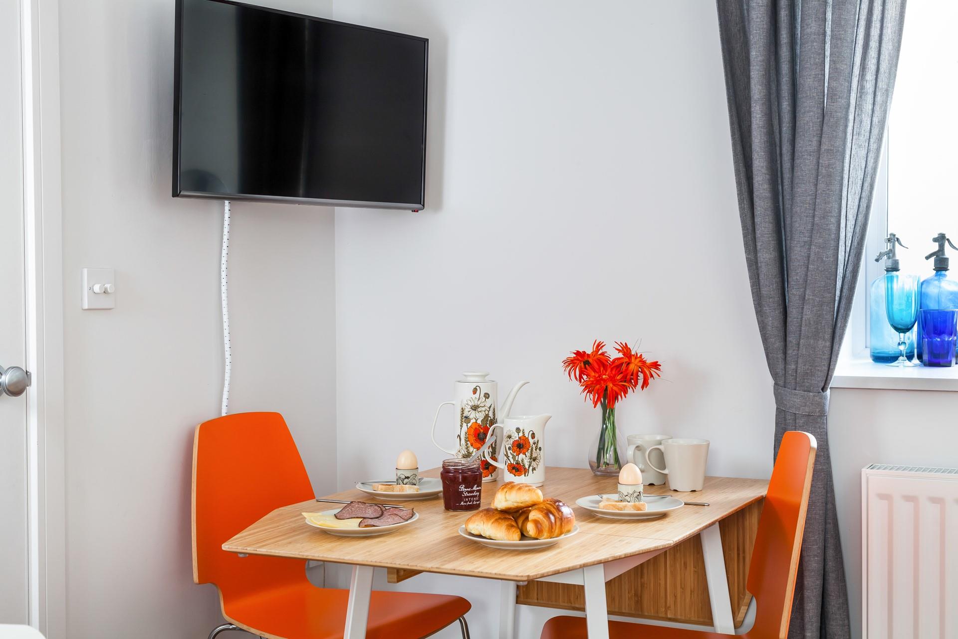 Pops of colour and retro furniture add to the style and fun of the apartment!