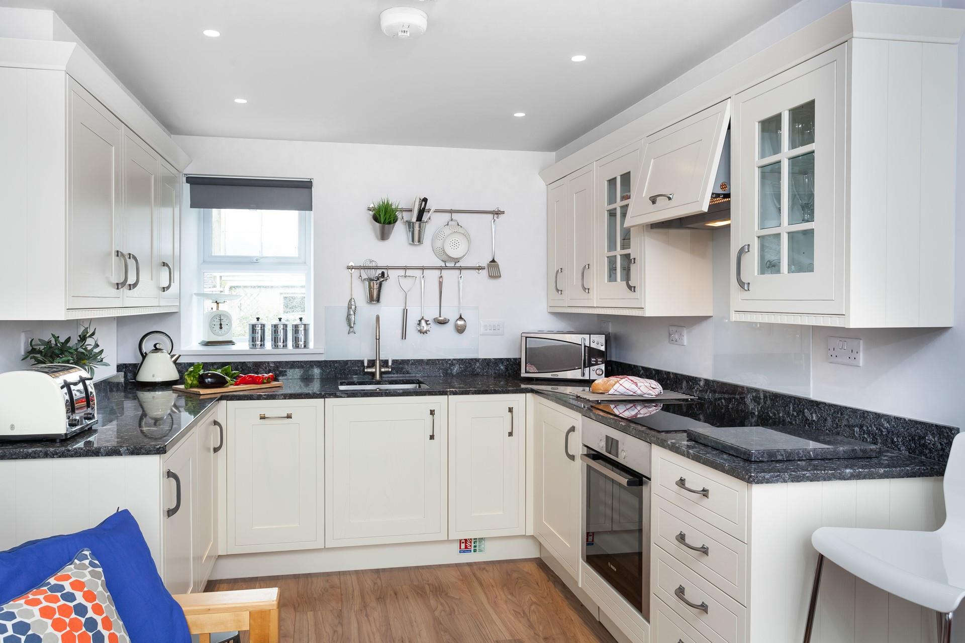 Beautifully designed with a sleek, modern finish, the kitchen is perfect for whipping up delicious meals.