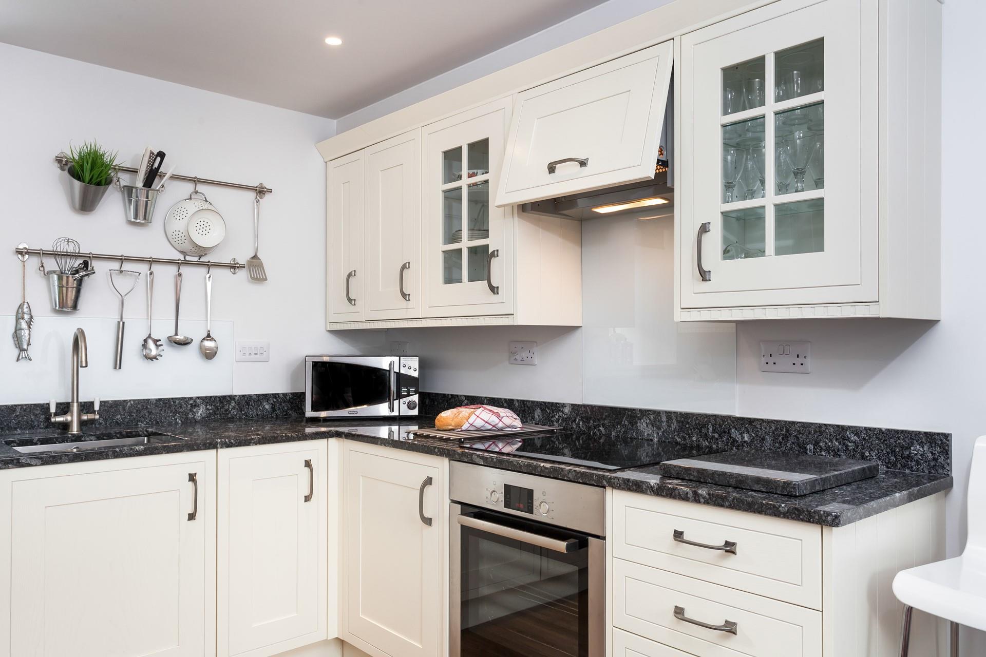 Light cabinets and wood effect flooring have created a bright and airy space.