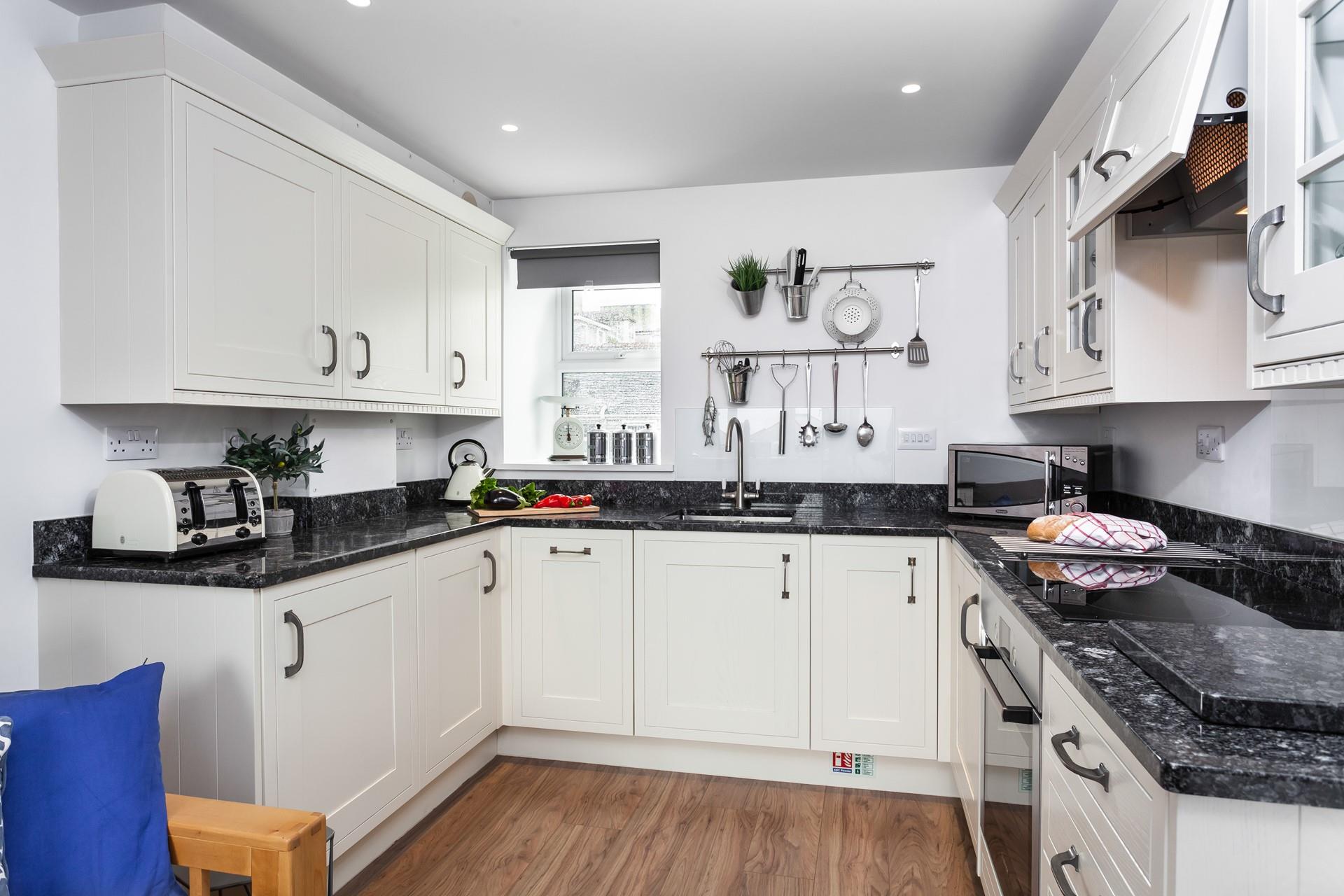 This well-equipped kitchen with modern appliances is sure to delight any budding chef.