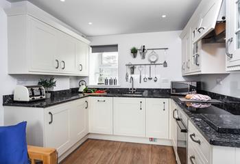 This well-equipped kitchen with modern appliances is sure to delight any budding chef.
