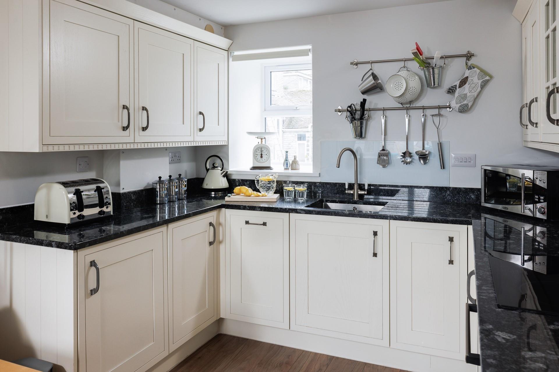 Light cabinets and wood effect flooring have created a bright and airy space.