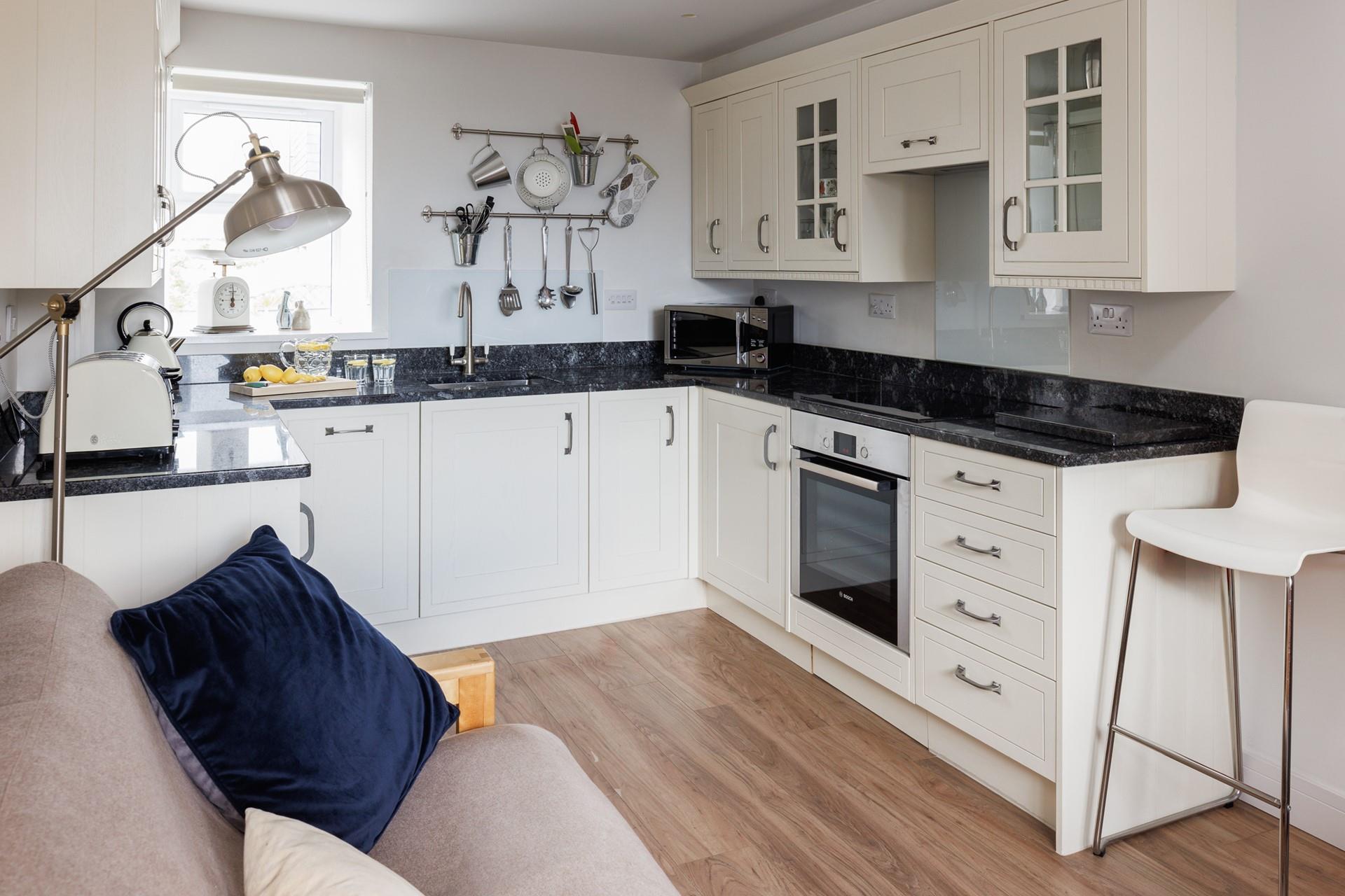 This well-equipped kitchen with modern appliances is sure to delight any budding chef.