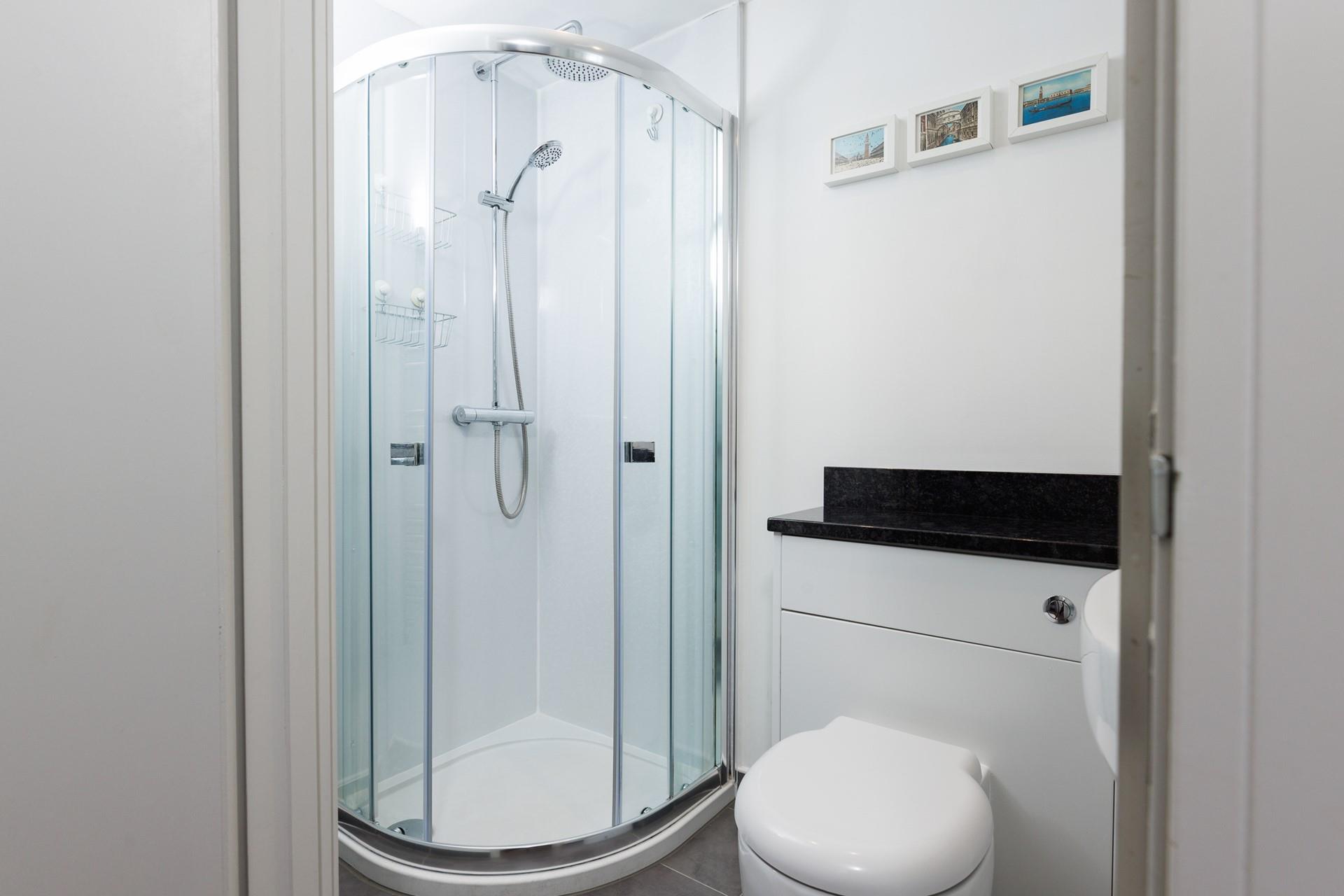 Start your day with an invigorating shower in the sleek bathroom.