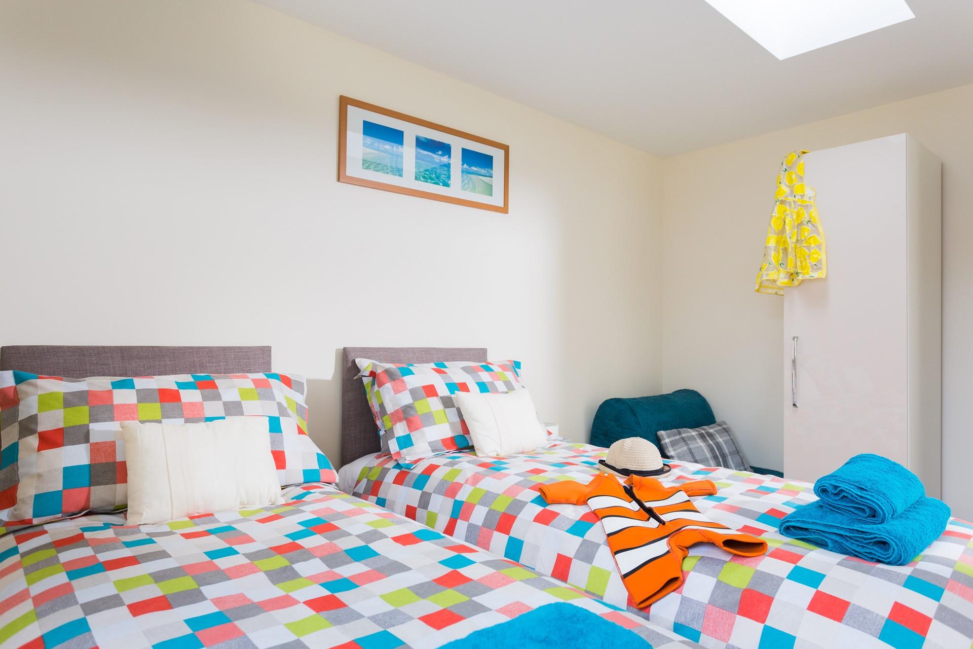 The room has colourful yet minimalistic decor, the perfect space to relax after a day of exploring Newquay!