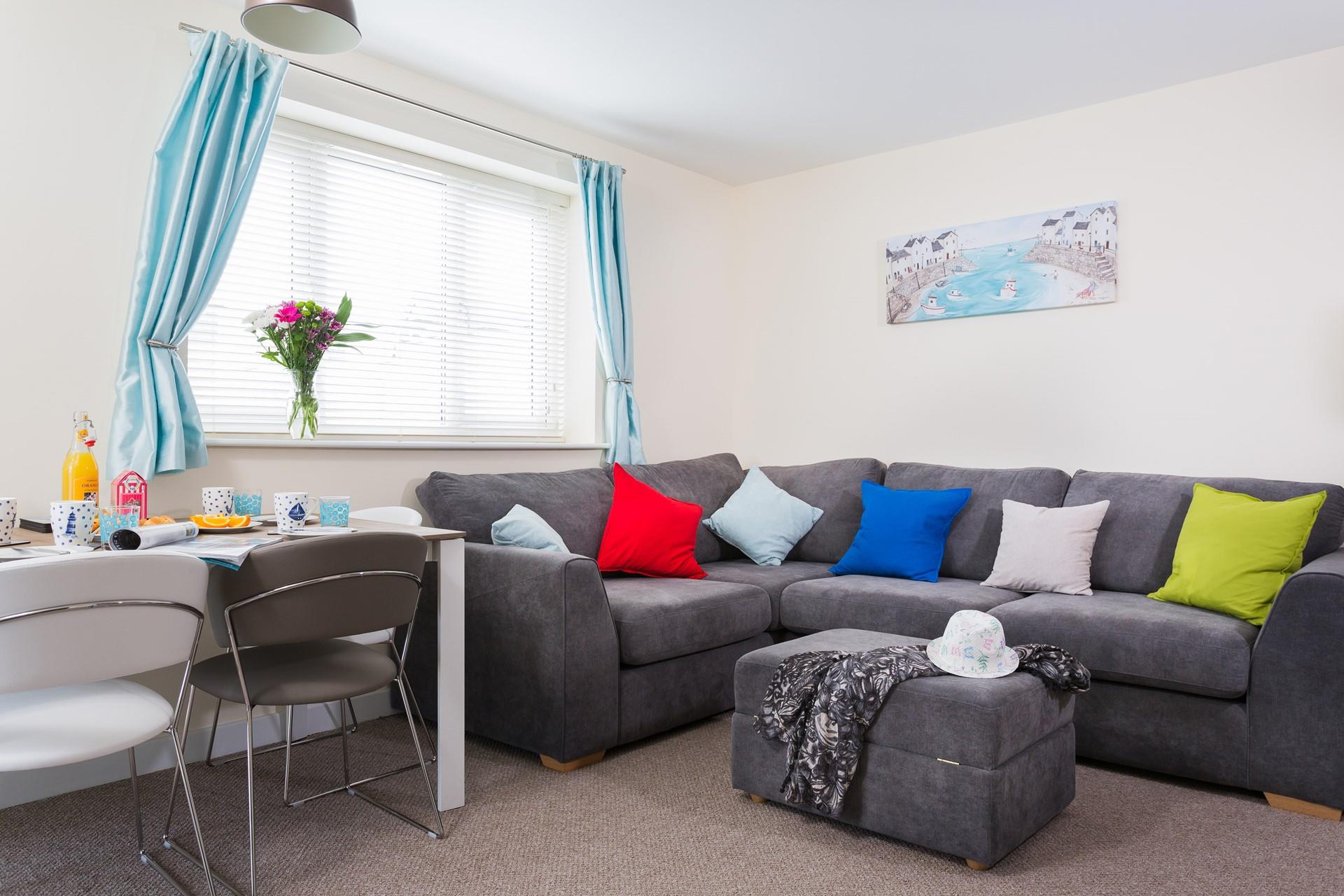 Large windows and a comfy corner sofa give this area a bright and spacious feel.