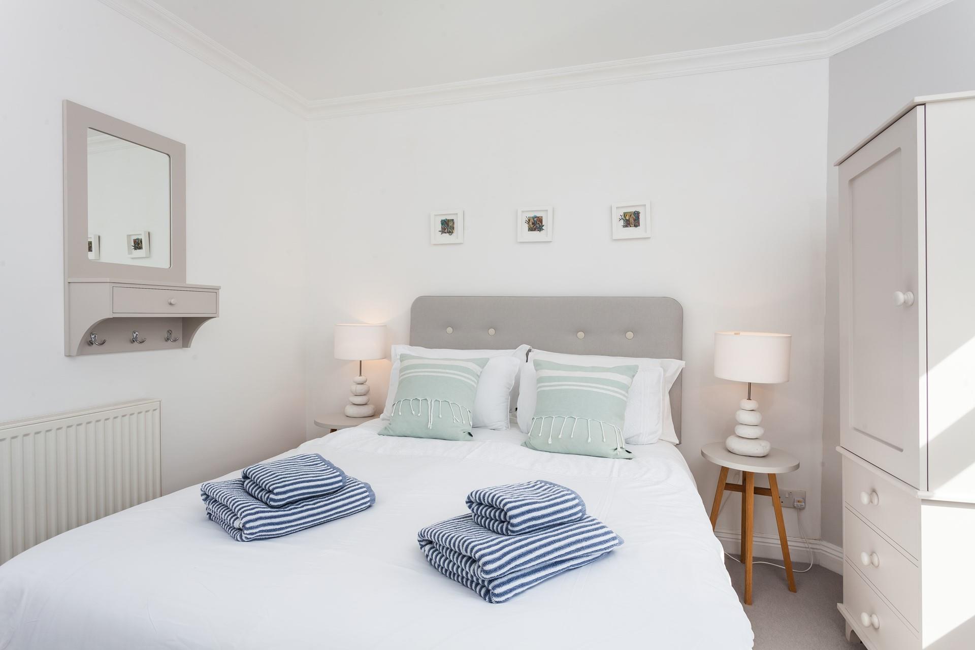 The minimalistic design and cool colours have created a calming space to unwind and drift off.