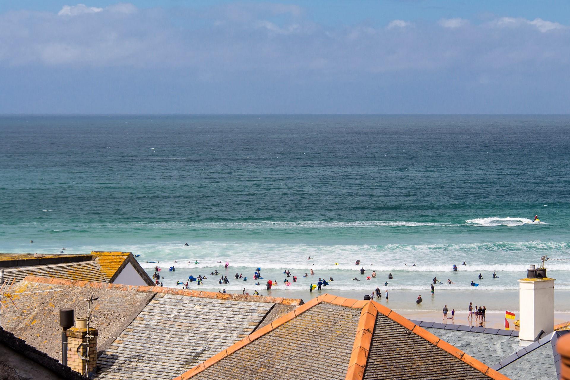 Porthmeor beach is very popular for swimming and surfing in the beautiful St Ives blue sea.