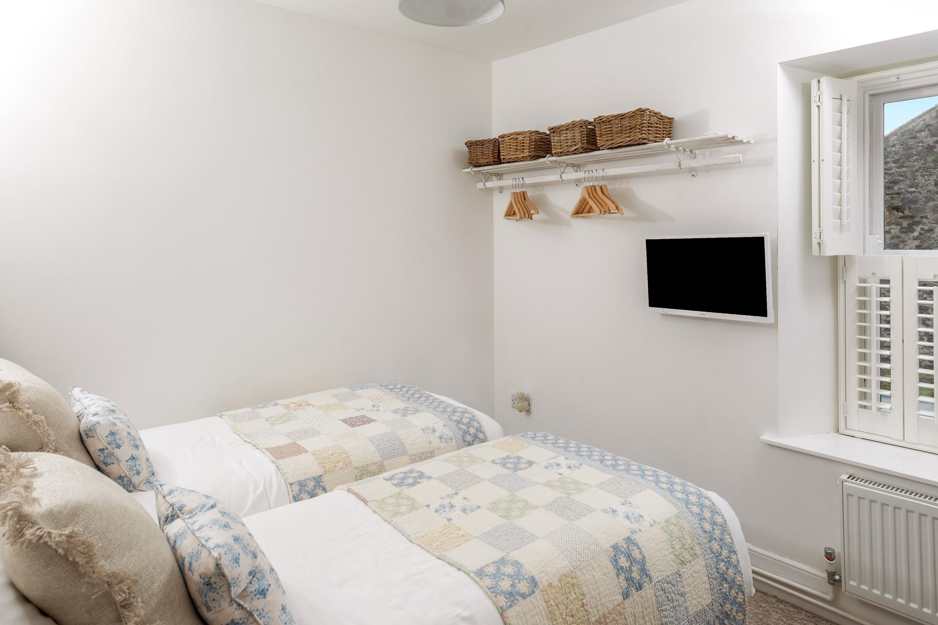 Bedroom 2 has twin beds perfect for young adults or children.