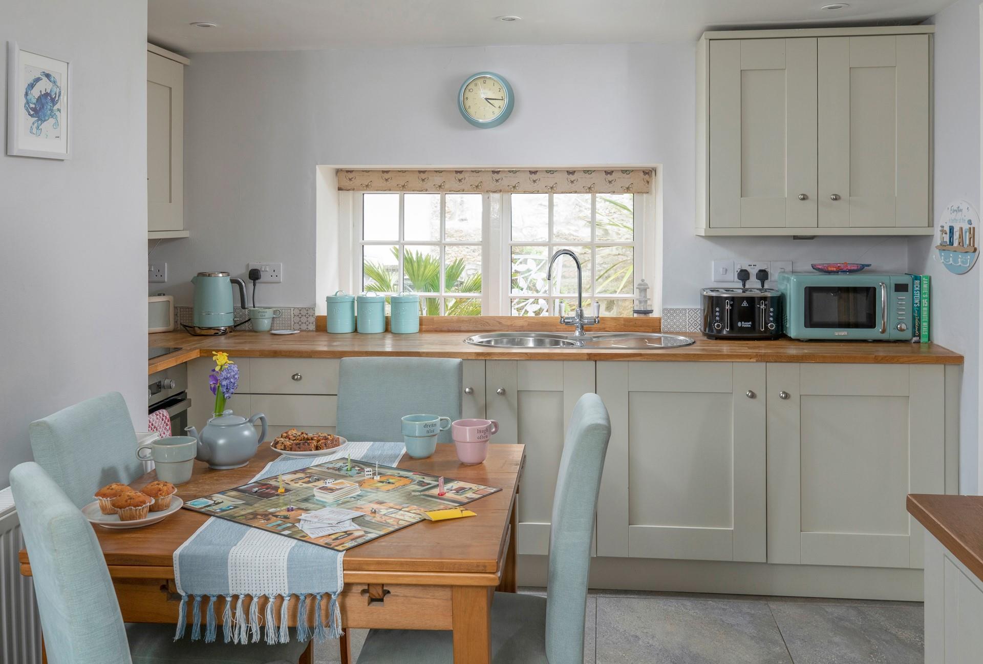 The dining table with seating for four is perfect for holiday meals and games night!