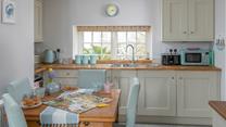 The dining table with seating for four is perfect for holiday meals and games night!