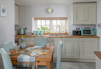 The dining table with seating for four is perfect for holiday meals and games night!
