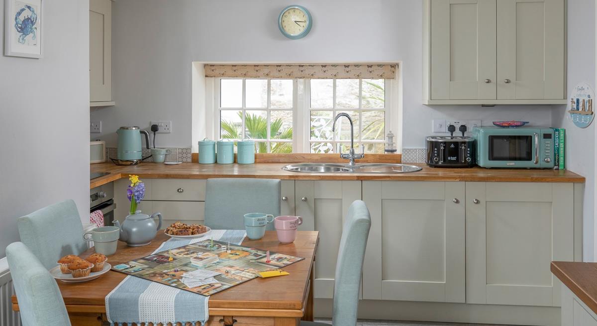 The dining table with seating for four is perfect for holiday meals and games night!