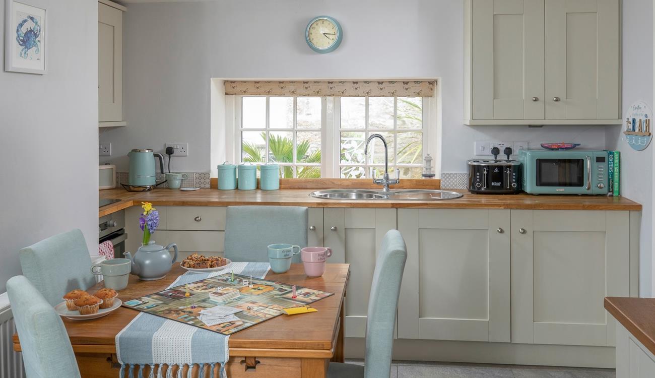 The dining table with seating for four is perfect for holiday meals and games night!