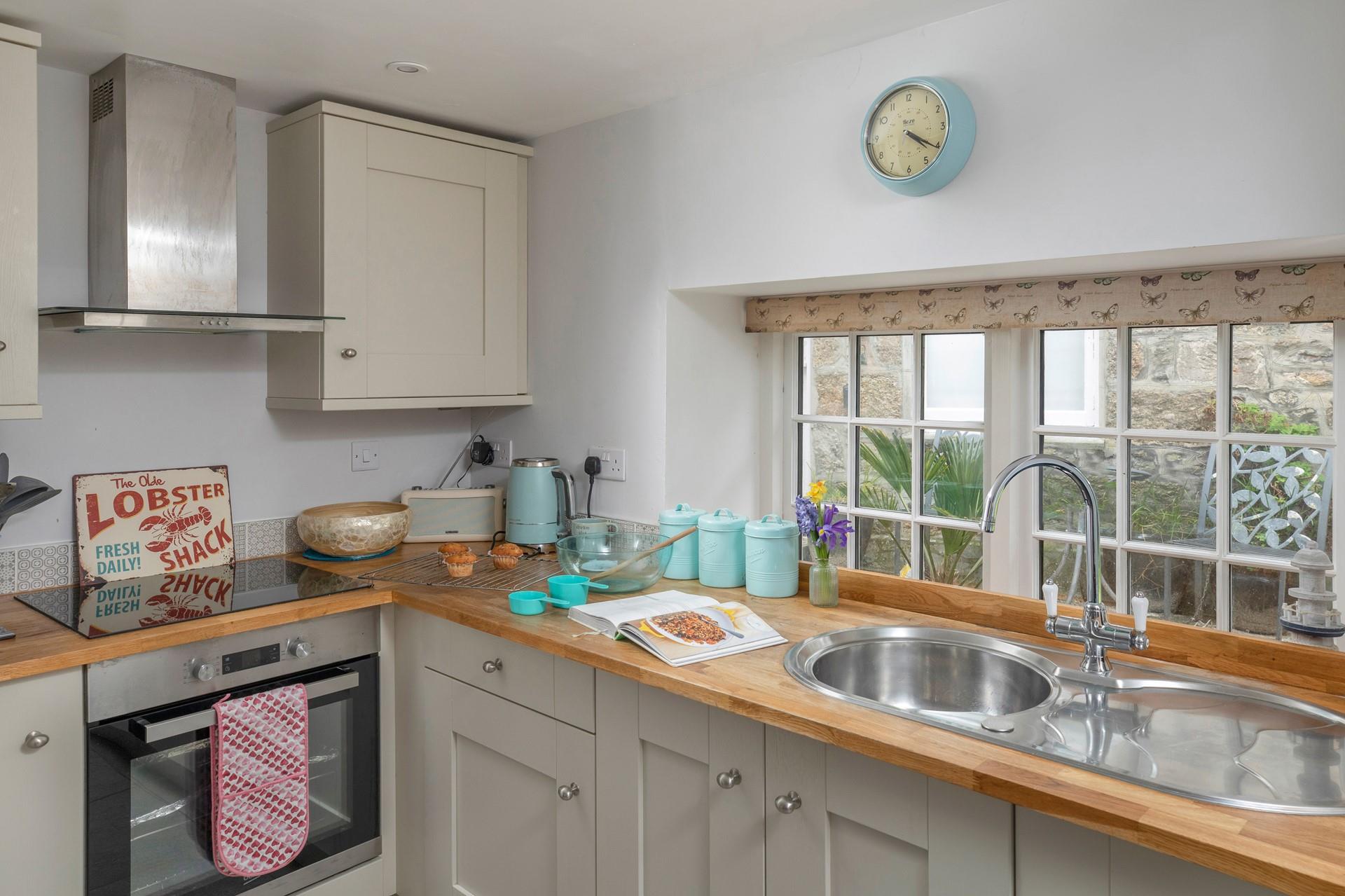 The kitchen is light and bright, with all the amenities you need.