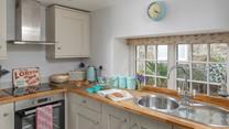 The kitchen is light and bright, with all the amenities you need.