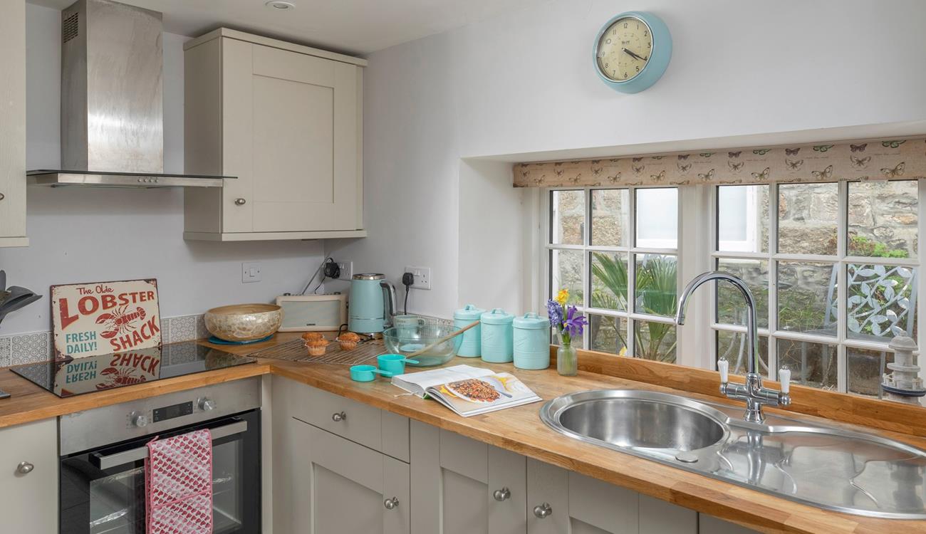 The kitchen is light and bright, with all the amenities you need.