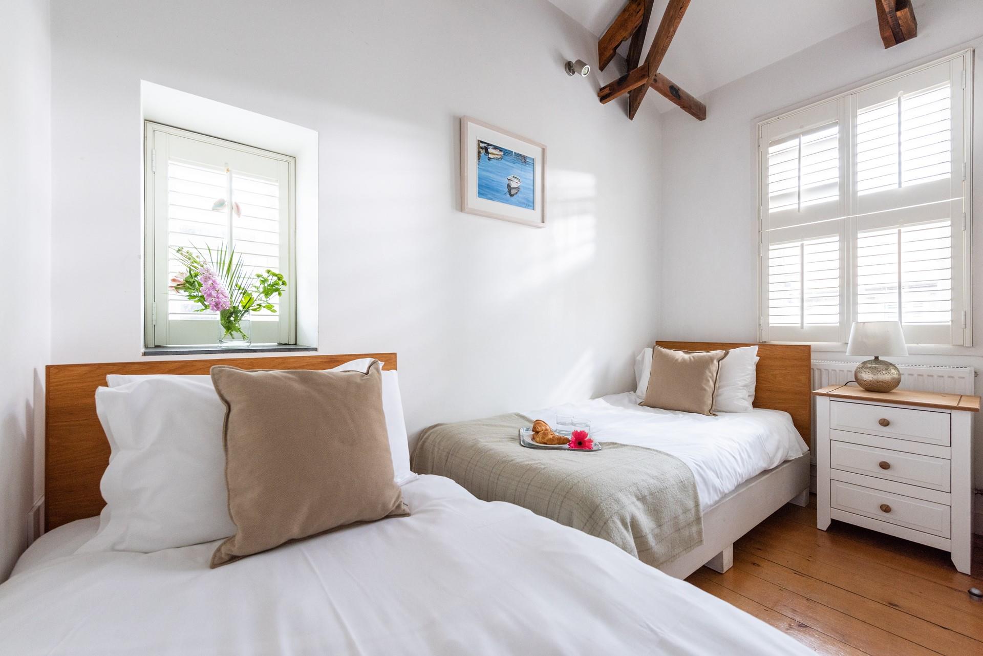 Bedroom 2 has twin beds perfect for kids or adults.