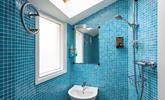 The ground floor wet room is fully tiled in a cool blue mosaic tiling, perfect for washing off sandy toes. - Thumbnail Image