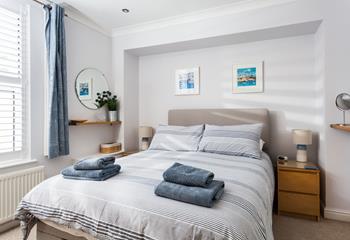 A soft colour palette and comfortable bed promise a blissful night's sleep in the bedroom.