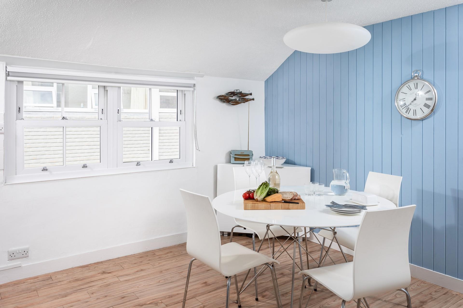 The statement blue wall adds a fabulous nautical feel to the room.