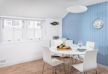 The statement blue wall adds a fabulous nautical feel to the room.