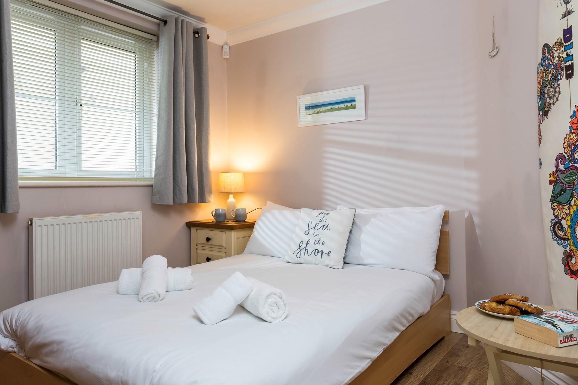 Bedroom 2 has a spacious double bed perfect for a relaxing night's sleep.