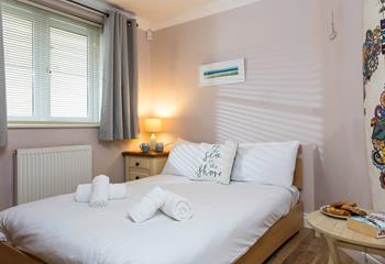 Bedroom 2 has a spacious double bed perfect for a relaxing night's sleep.