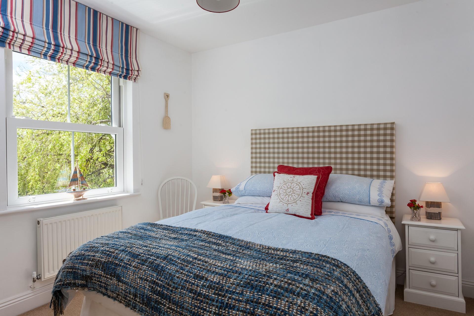 Bedroom 1 has a nautical blue and red theme.
