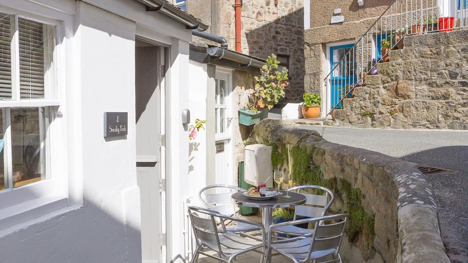 The outside area is a charming little sun trap, perfect for a morning coffee or an evening glass of wine.