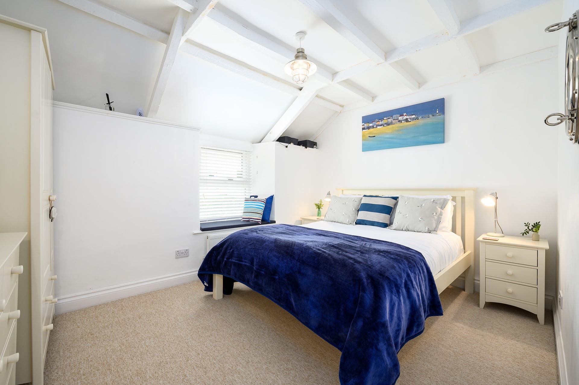 Slanted ceilings and exposed beams hint at the property's history, adding character to this charming home.