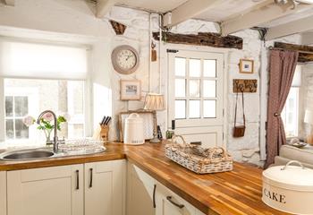 The country-style kitchen is an enchanting space to whip up delicious meals for your loved ones.