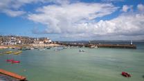 Watch the boats bobbing in the harbour as the sun rises for another beach day.