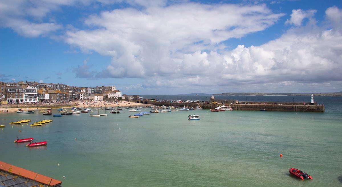 Watch the boats bobbing in the harbour as the sun rises for another beach day.