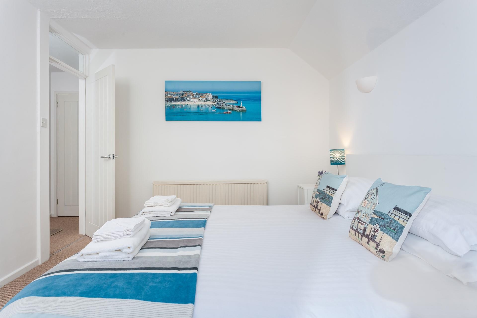 Bedroom 2 features calming blue and white interiors for you to enjoy a relaxing night's sleep.