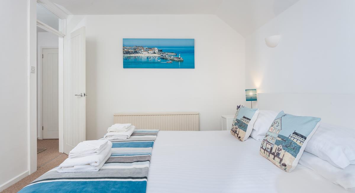 Bedroom 2 features calming blue and white interiors for you to enjoy a relaxing night's sleep.