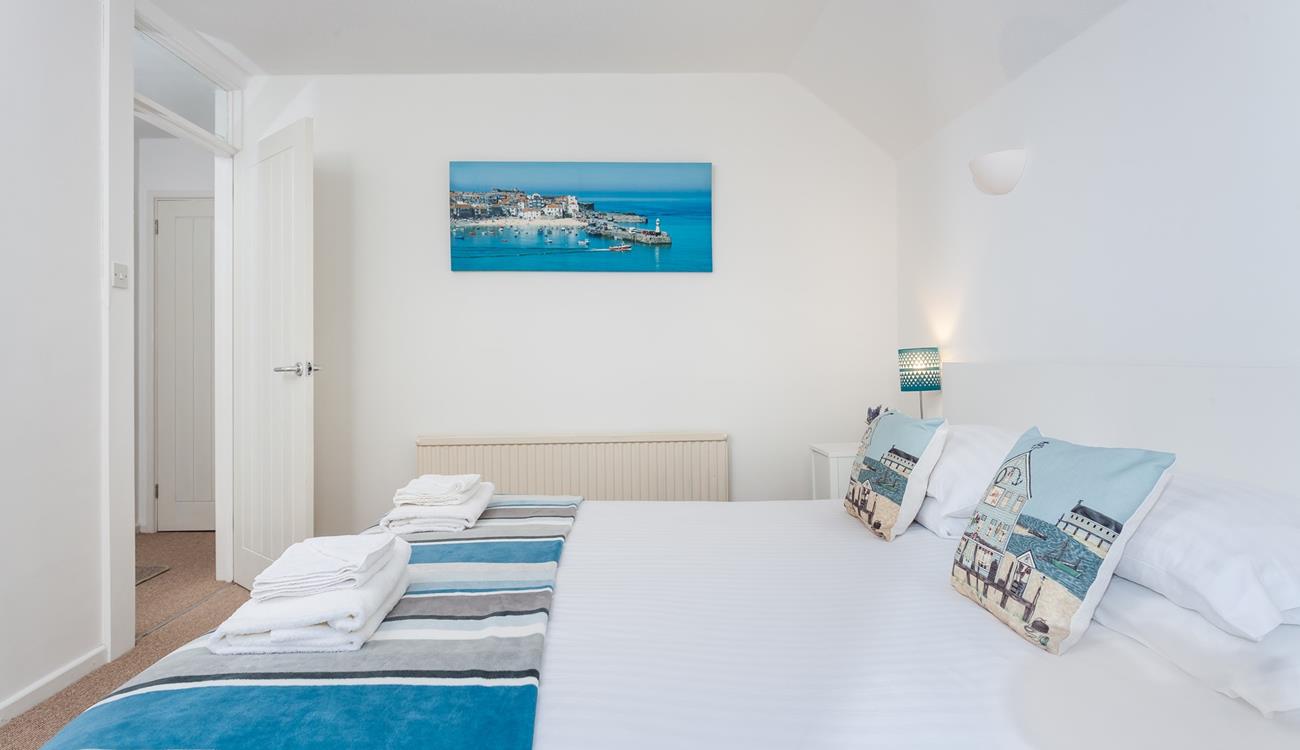 Bedroom 2 features calming blue and white interiors for you to enjoy a relaxing night's sleep.