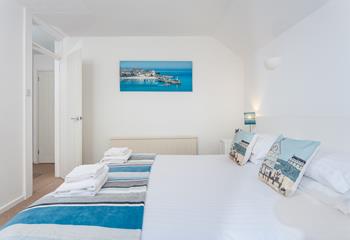 Bedroom 2 features calming blue and white interiors for you to enjoy a relaxing night's sleep.