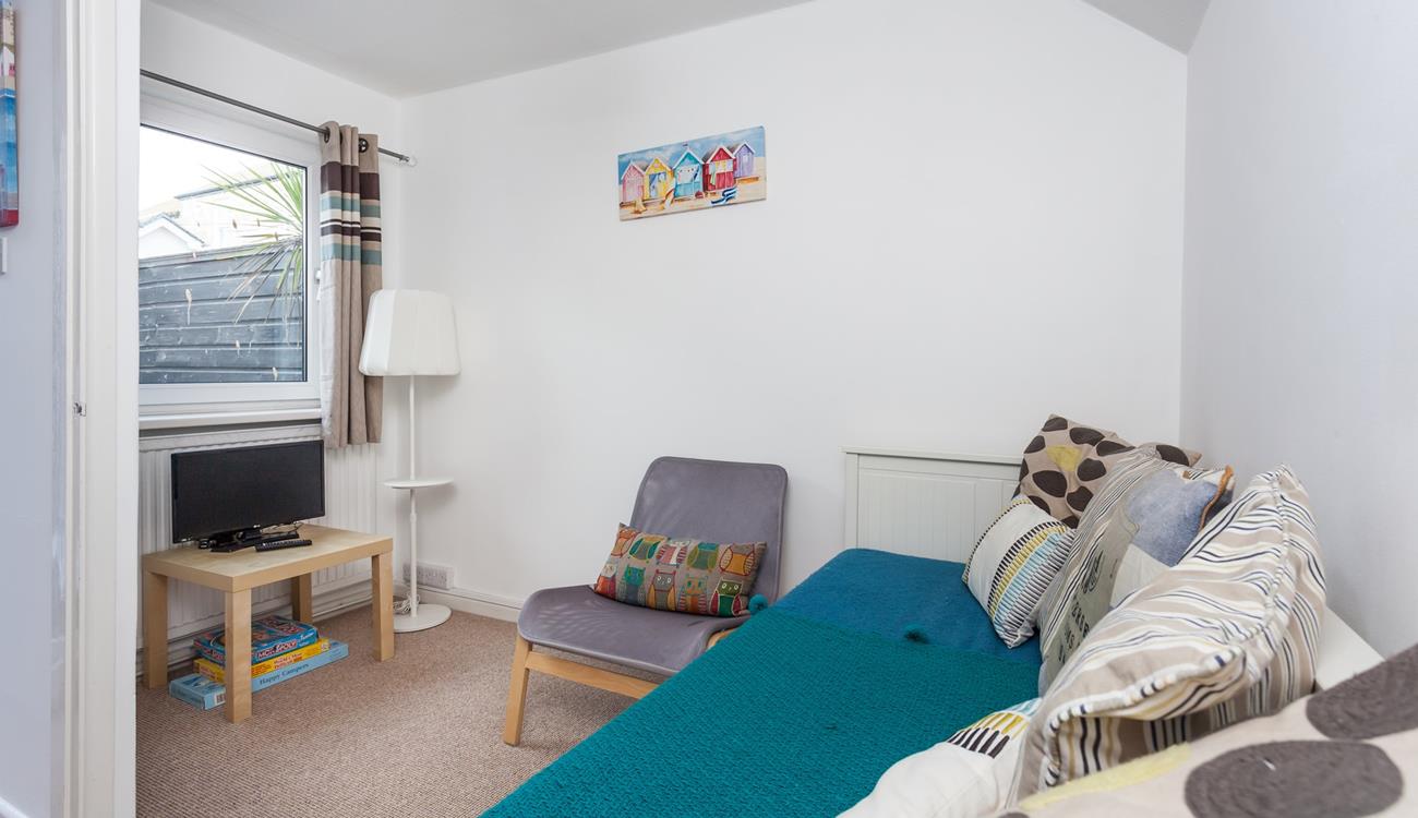 The snug room provides a quiet space to unwind.