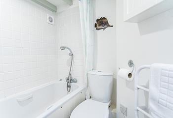 The main bathroom in Castle Cottage has a bath which is perfect for washing off sandy feet after a day at the beach!