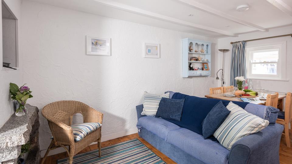 Decorated in hues reminiscent of the seaside, the living area is the perfect cosy space to snuggle up.