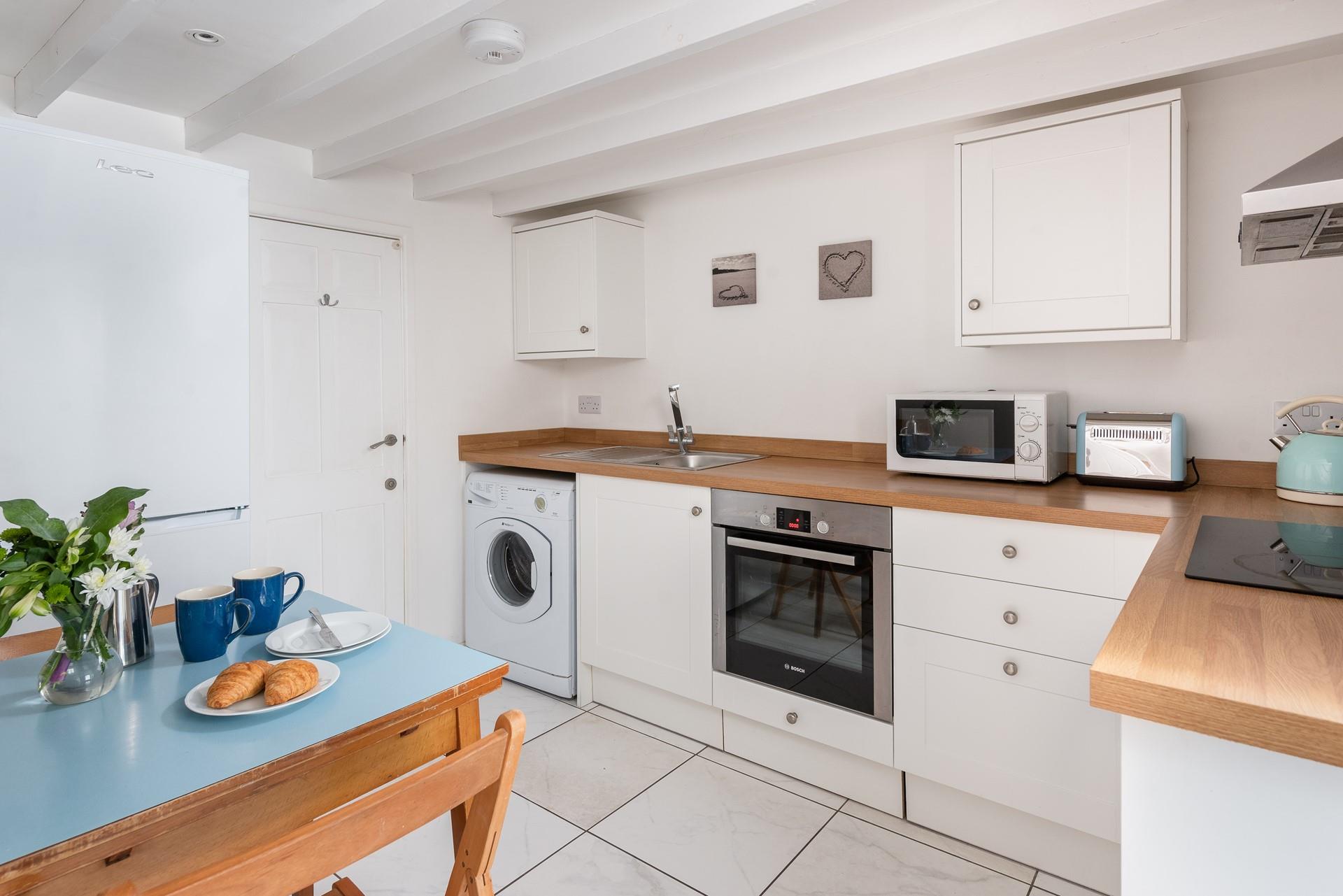 The modern kitchen is a chic space complete with modern appliances to make cooking up a feast a breeze.