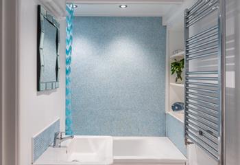The bathroom is located on the ground floor and benefits from a bath with a shower.
