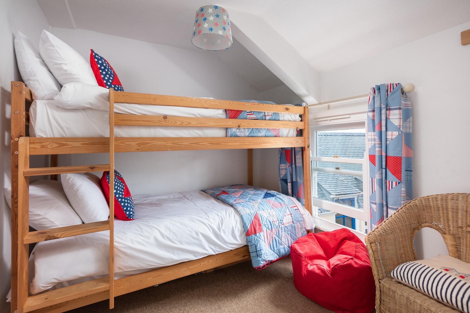 This fun and colourful room with bunk beds is sure to delight children! 