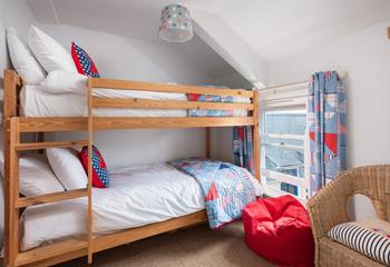This fun and colourful room with bunk beds is sure to delight children! 