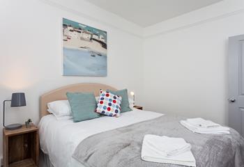Soft sheets and fluffy towels await in the bedrooms.