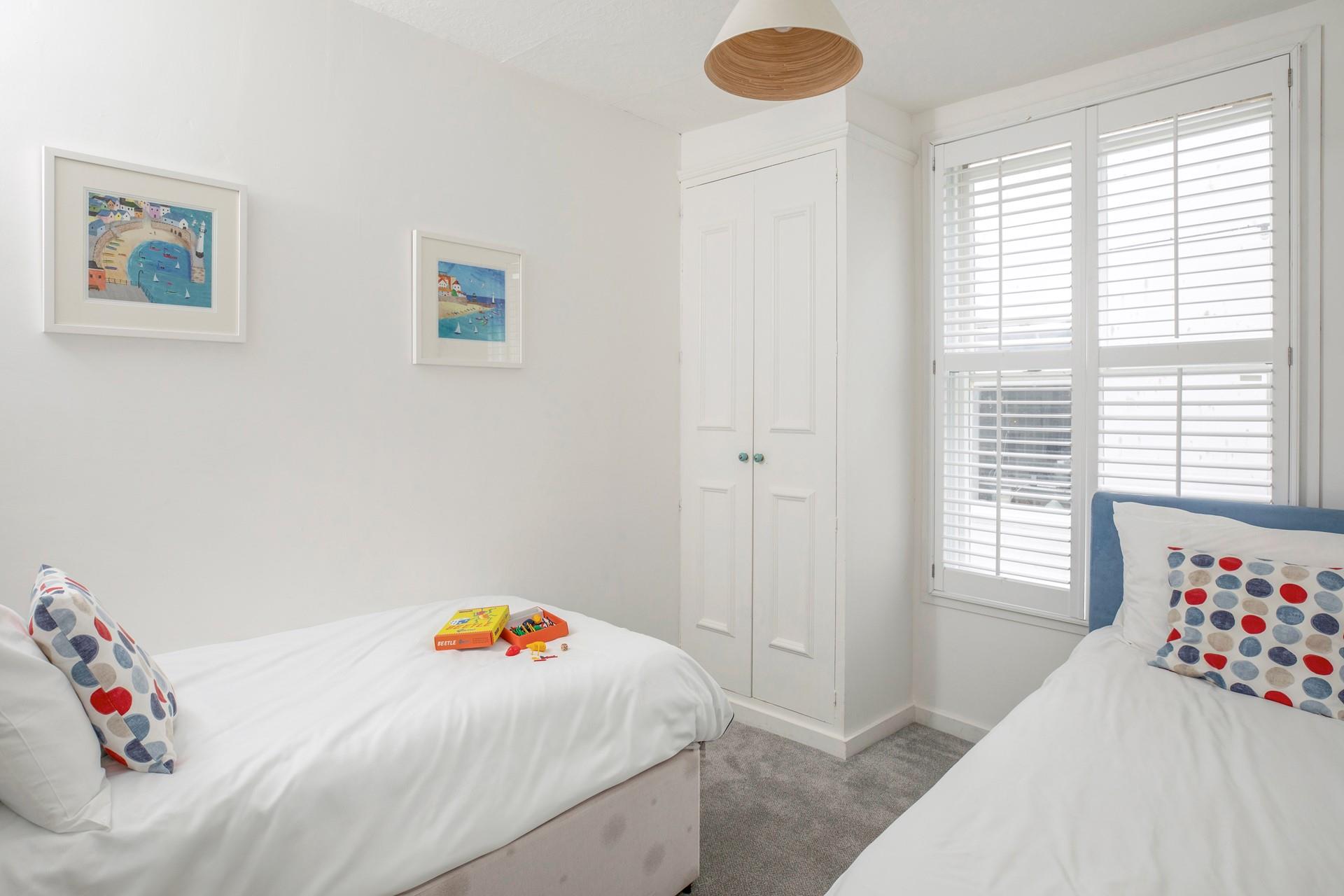 Settle the kids into the twin beds after an exhausting day spent on the beach.