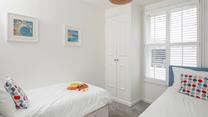 Settle the kids into the twin beds after an exhausting day spent on the beach.
