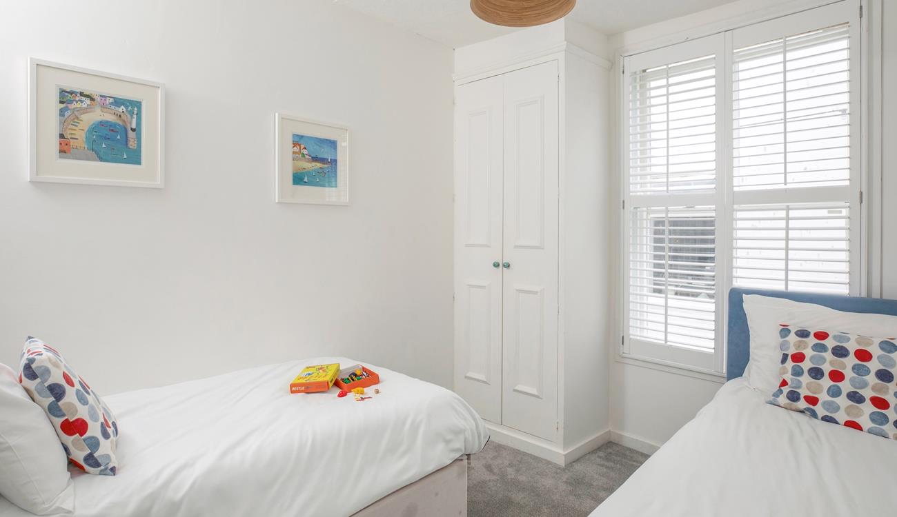 Settle the kids into the twin beds after an exhausting day spent on the beach.