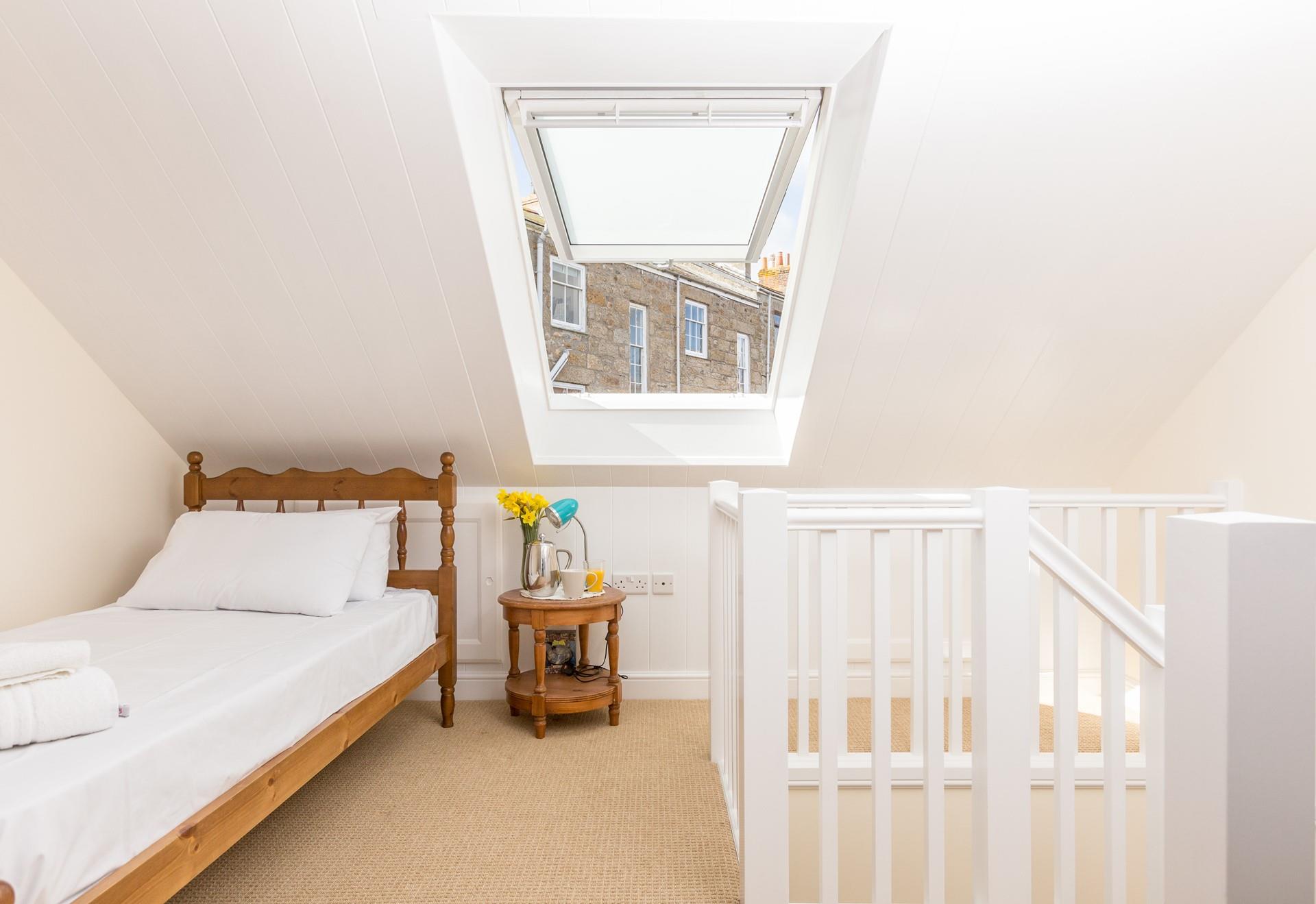Natural light floods into the single bedroom.